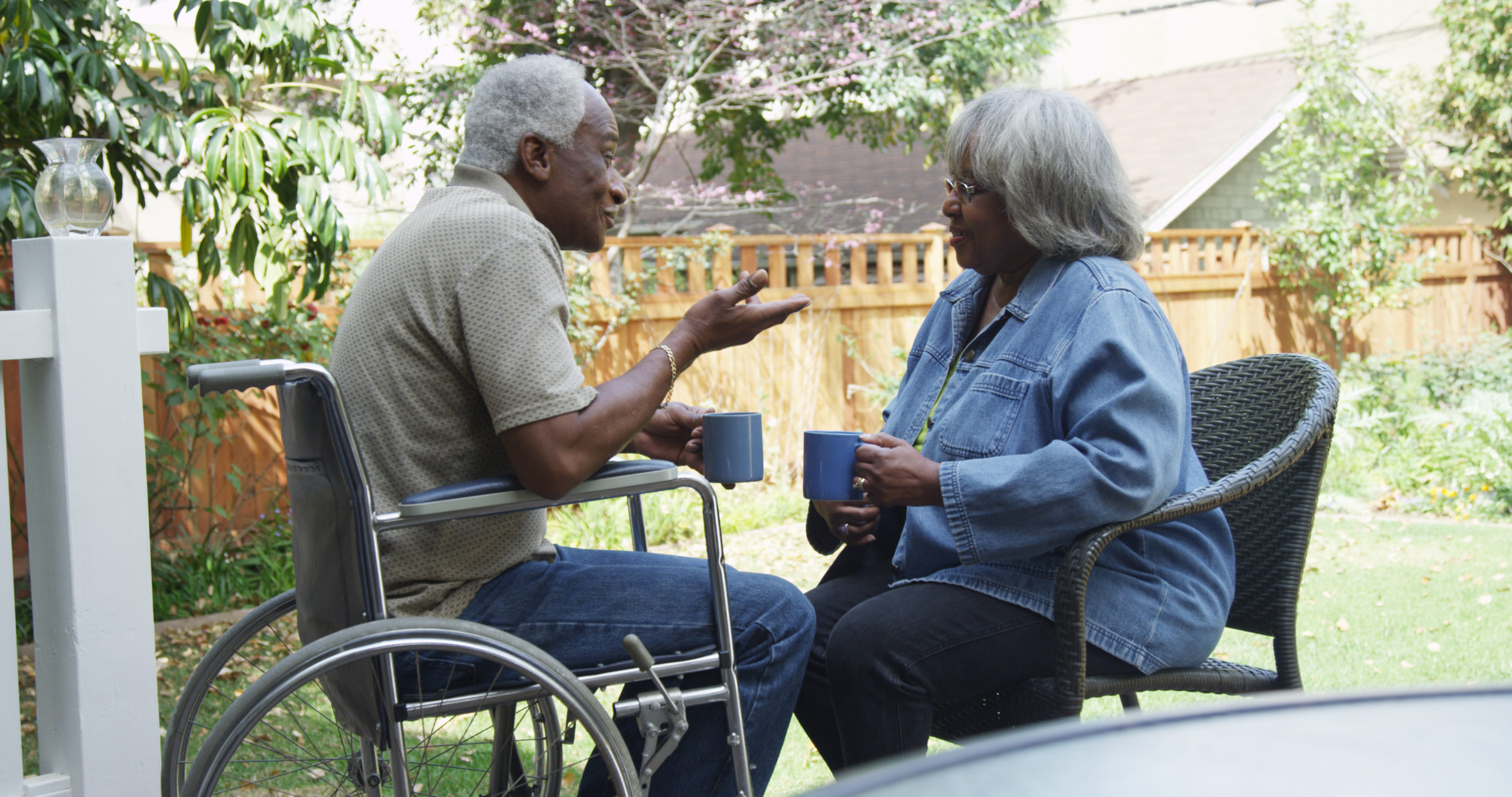 Disabled,Elderly,African,Man,Talking,With,Wife,In,The,Backyard