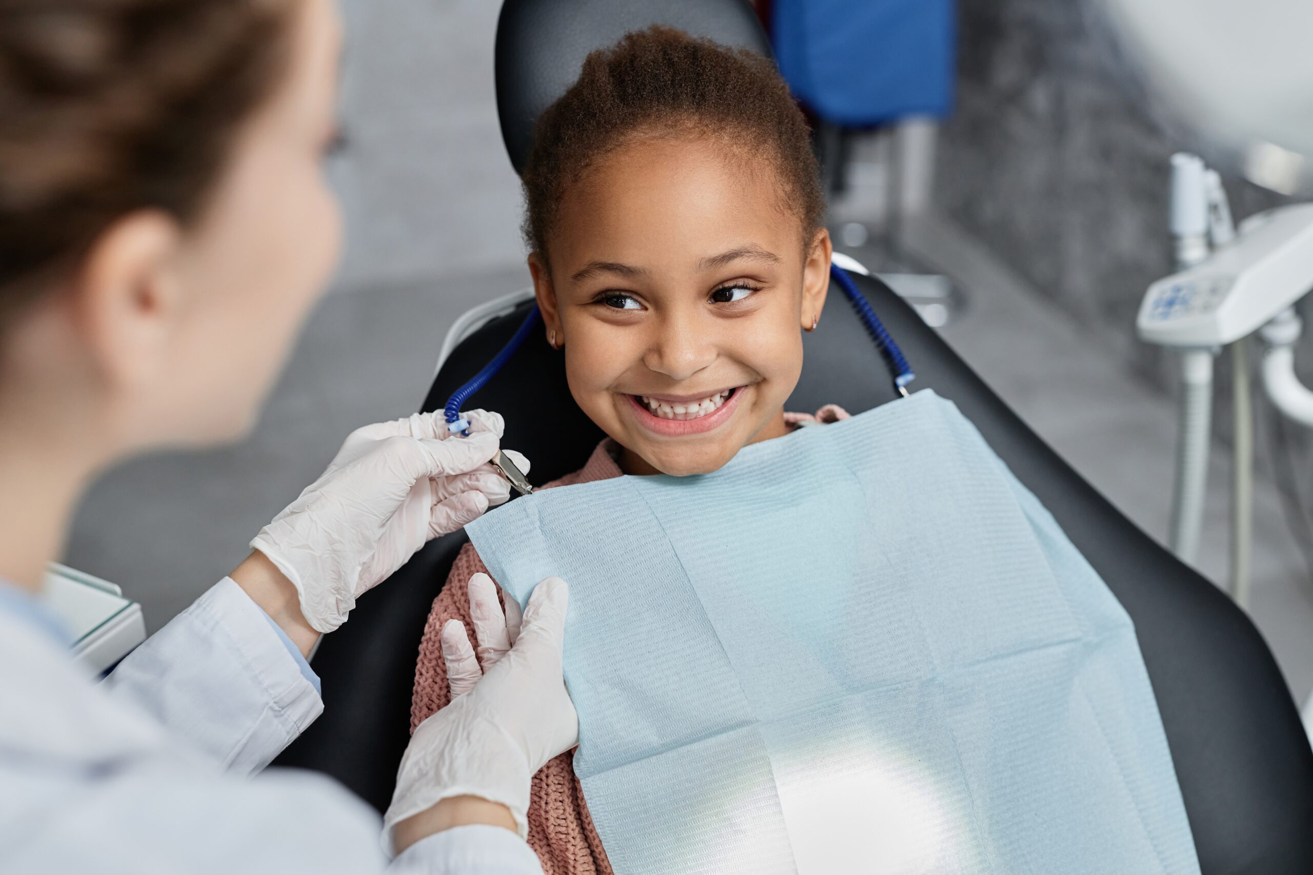 Portrait,Of,Smiling,Little,Girl,In,Dental,Chair,With,Nurse Portrait,Of,Smiling,Little,Girl,In,Dental,Chair,With,Nurse